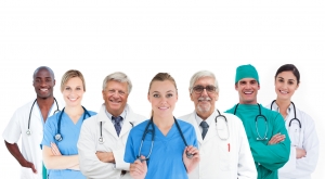 Smiling medical team standing arms crossed in line on white background